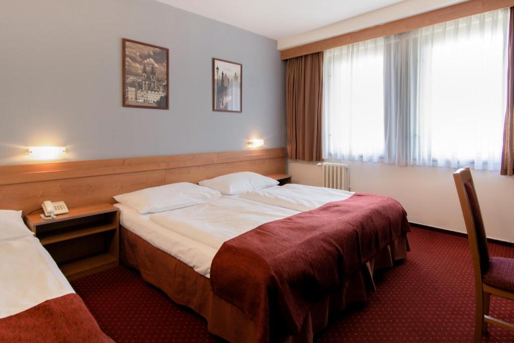 Postel nebo postele na pokoji v ubytování Hotel Globus