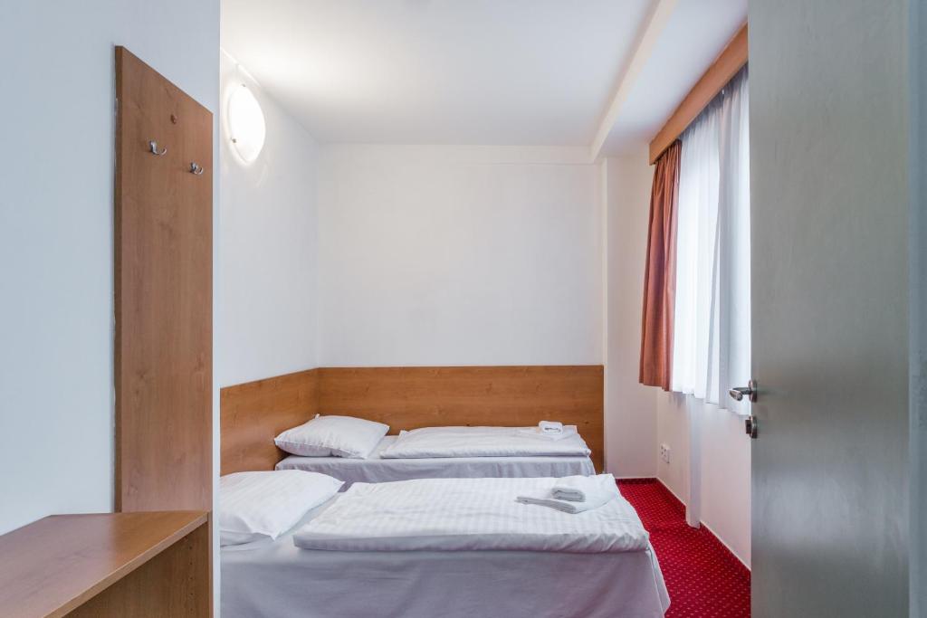 Postel nebo postele na pokoji v ubytování Hotel Globus