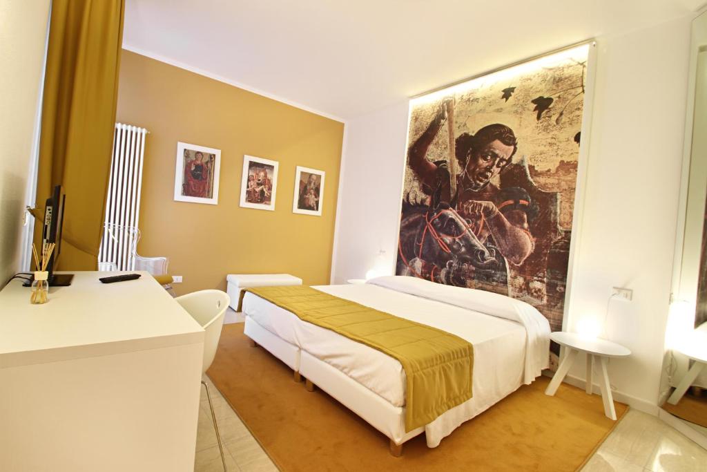 Łóżko lub łóżka w pokoju w obiekcie Ferrara Rooms