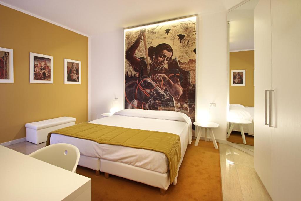 Łóżko lub łóżka w pokoju w obiekcie Ferrara Rooms