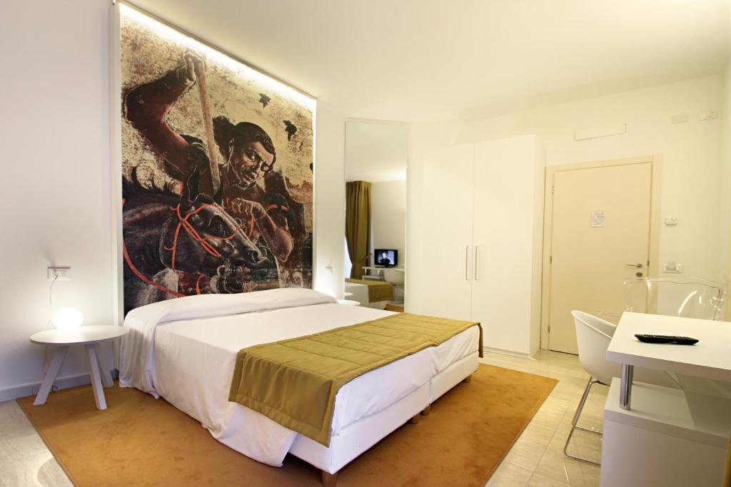 Łóżko lub łóżka w pokoju w obiekcie Ferrara Rooms
