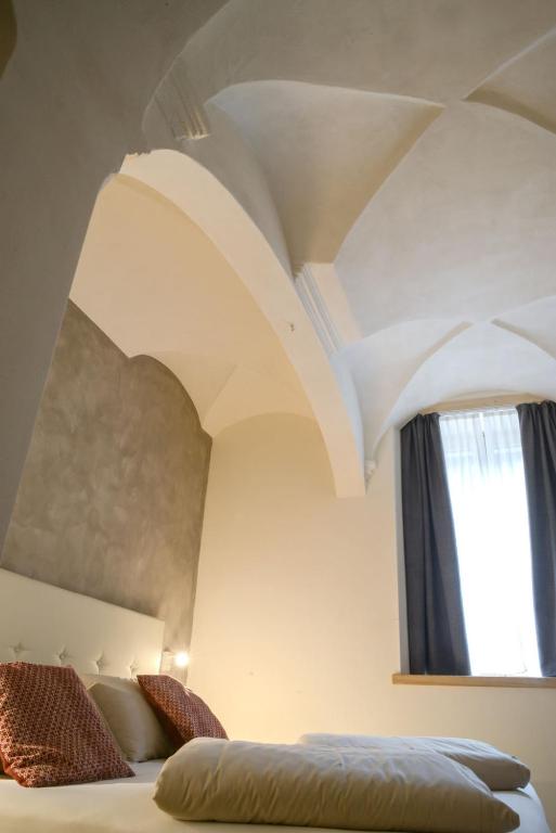 Postel nebo postele na pokoji v ubytování Hotel san Vitale