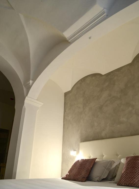 Postel nebo postele na pokoji v ubytování Hotel san Vitale