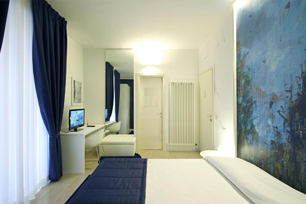 Łóżko lub łóżka w pokoju w obiekcie Ferrara Rooms