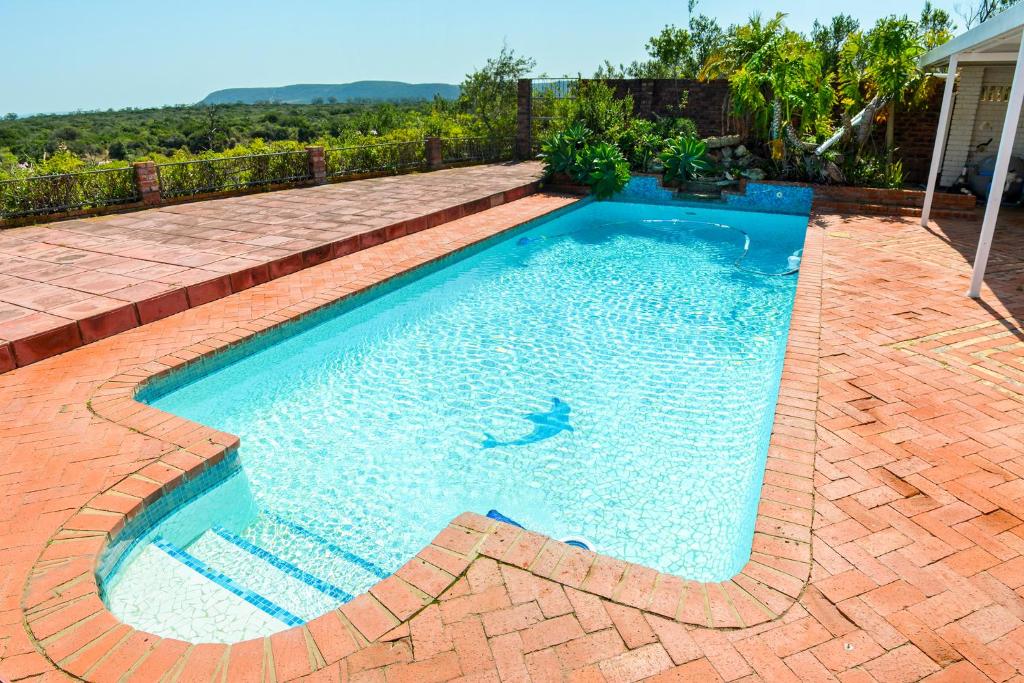 a swimming pool in a backyard with a brick patio at Sundaze Riverside House - Colchester - 5km from Elephant Park in Colchester