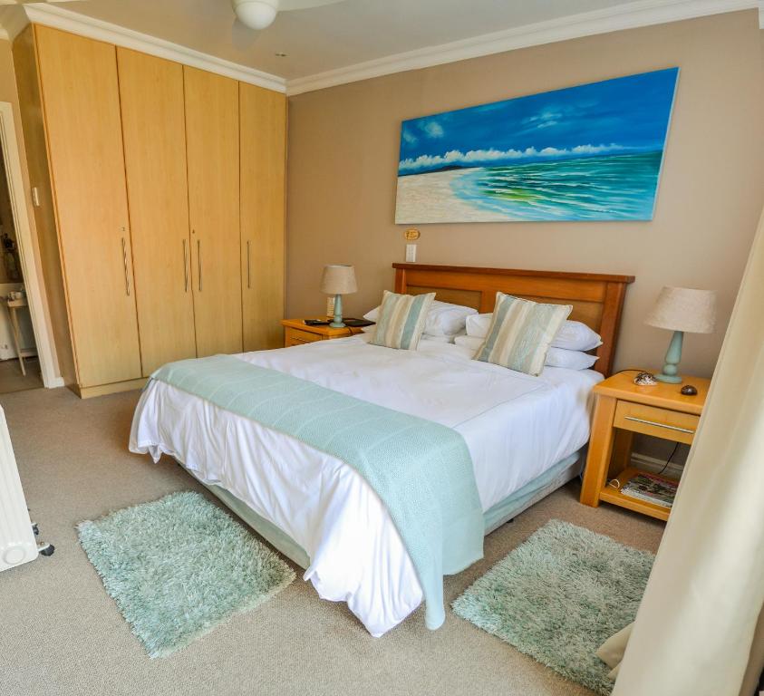 a bedroom with a large bed and two rugs at River Rooms - Chilled and Relaxed - Colchester - 5km from Elephant Park in Colchester