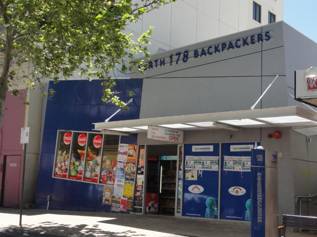 a gas station with a sign on the side of it at Perth 178 Backpackers in Perth