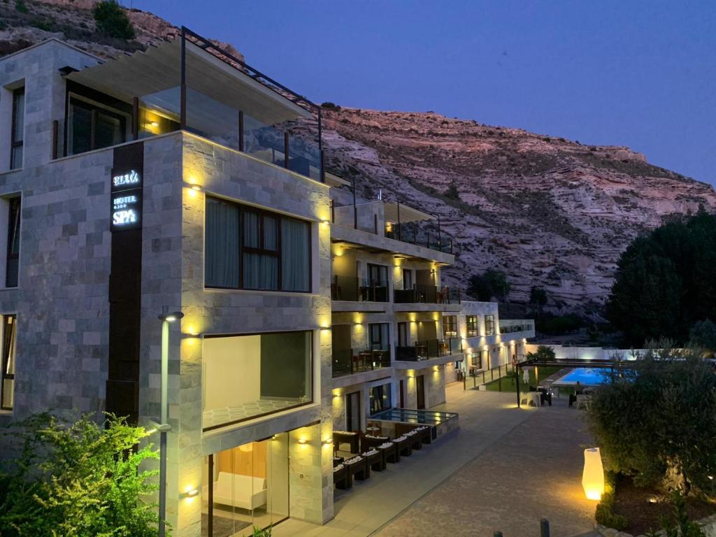 a building with lights in front of a mountain at Hotel Spa Elia in Alcalá del Júcar