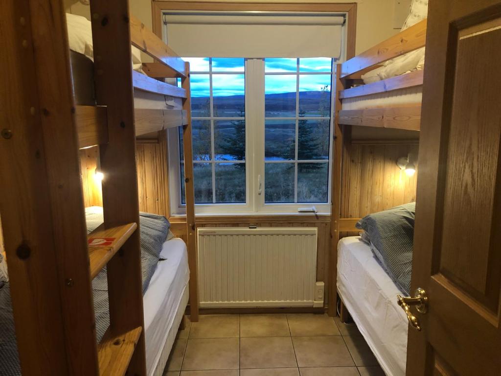 Postel nebo postele na pokoji v ubytování Eyjasol Cottages