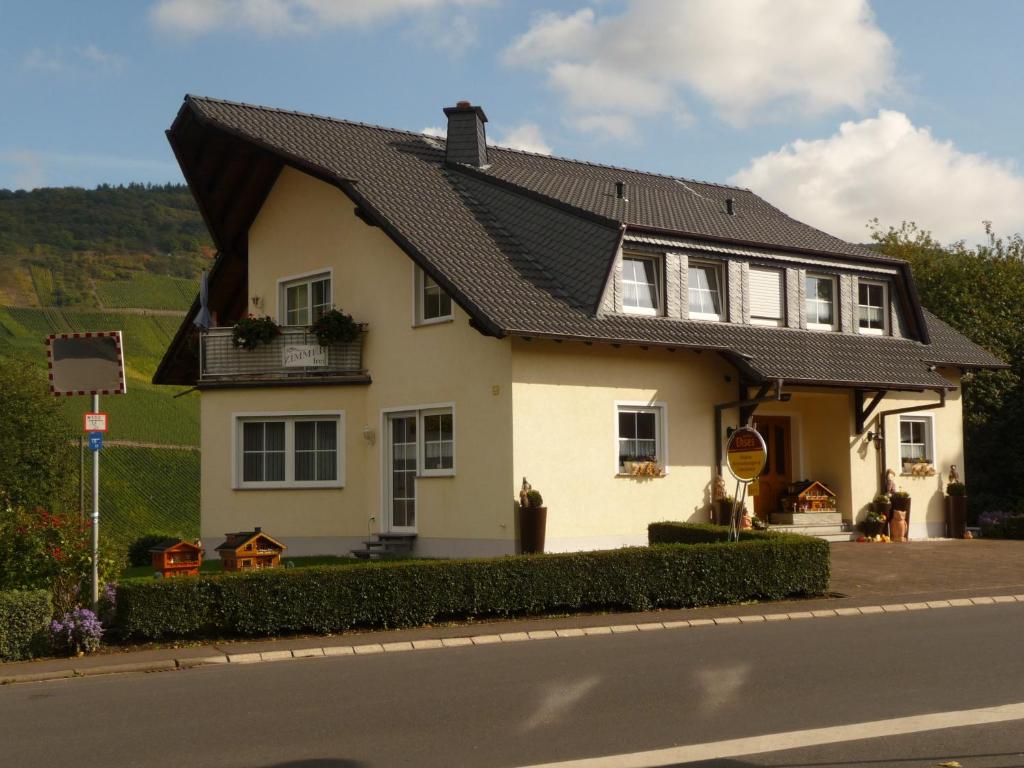 a white house with a black roof on a street at Gästehaus Ehses in Bernkastel-Kues