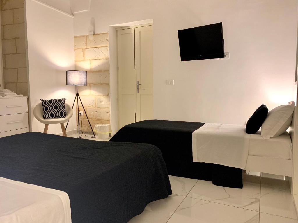 Postel nebo postele na pokoji v ubytování Dimora San Biagio Suites&Apartment