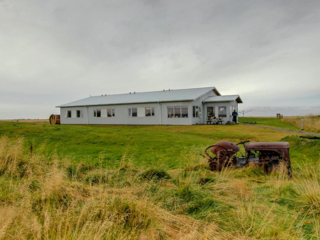 a white house in the middle of a field at Lambastadir Guesthouse in Selfoss