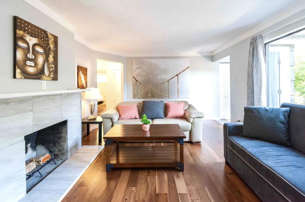 a living room with a couch and a fireplace at LOVELY HOME 10 MINUTES TO DOWNTOWN !!! in Victoria