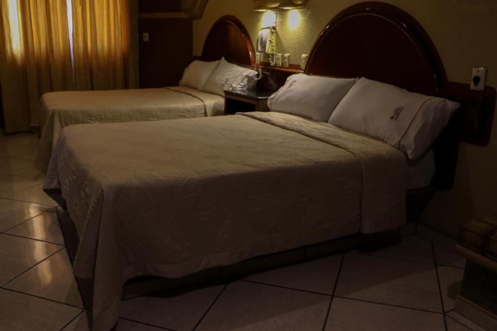 Postel nebo postele na pokoji v ubytování Motel Caribe