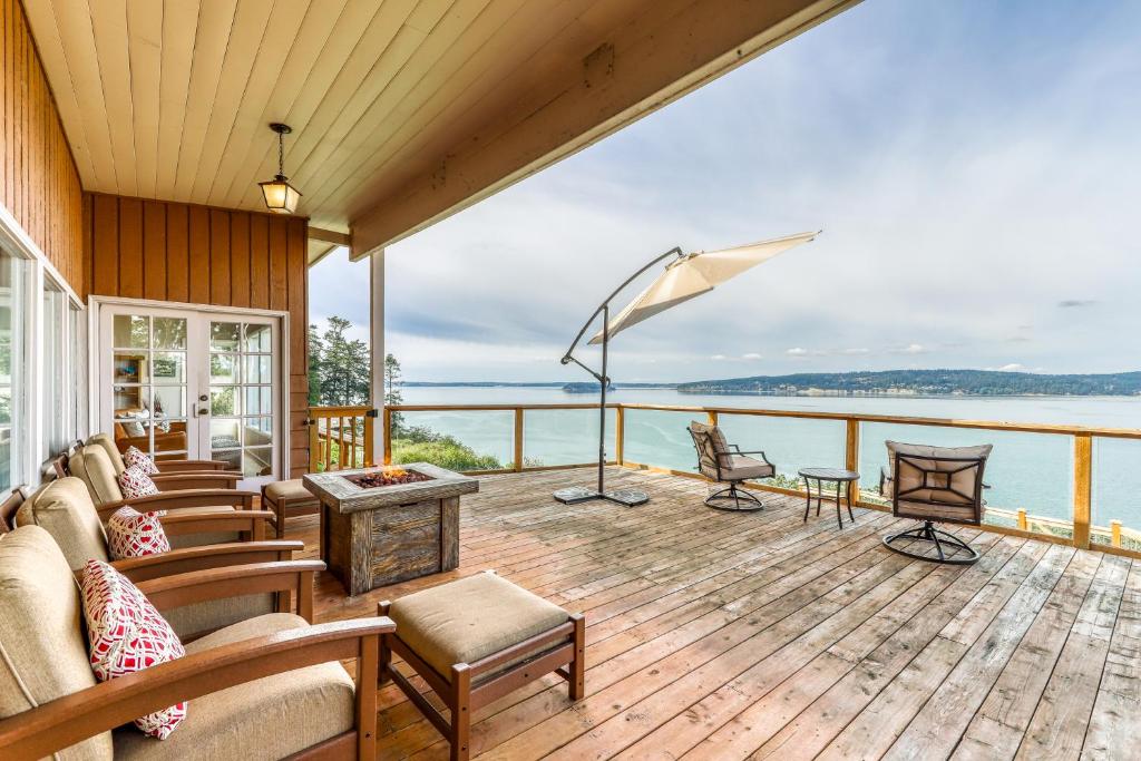 a house with a deck with a view of the water at Eagle's Nest Retreat in Maple Grove Beach