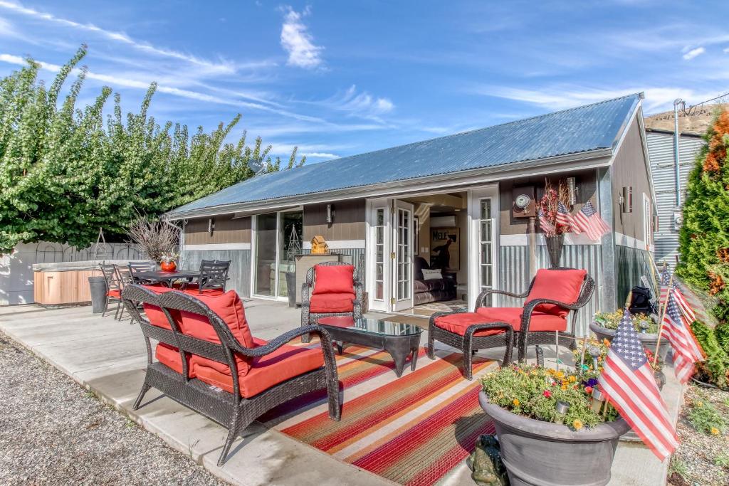 una casa con sillas rojas y una mesa en el patio en Apricot Ridge en East Wenatchee