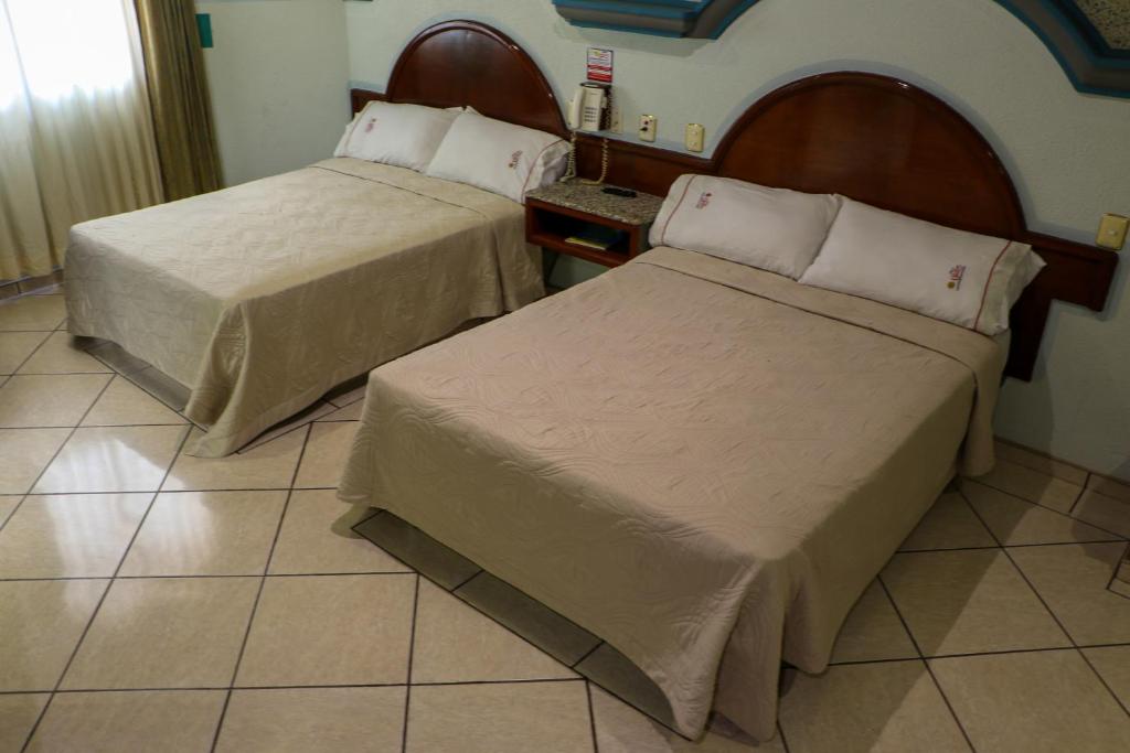 Postel nebo postele na pokoji v ubytování Motel Caribe