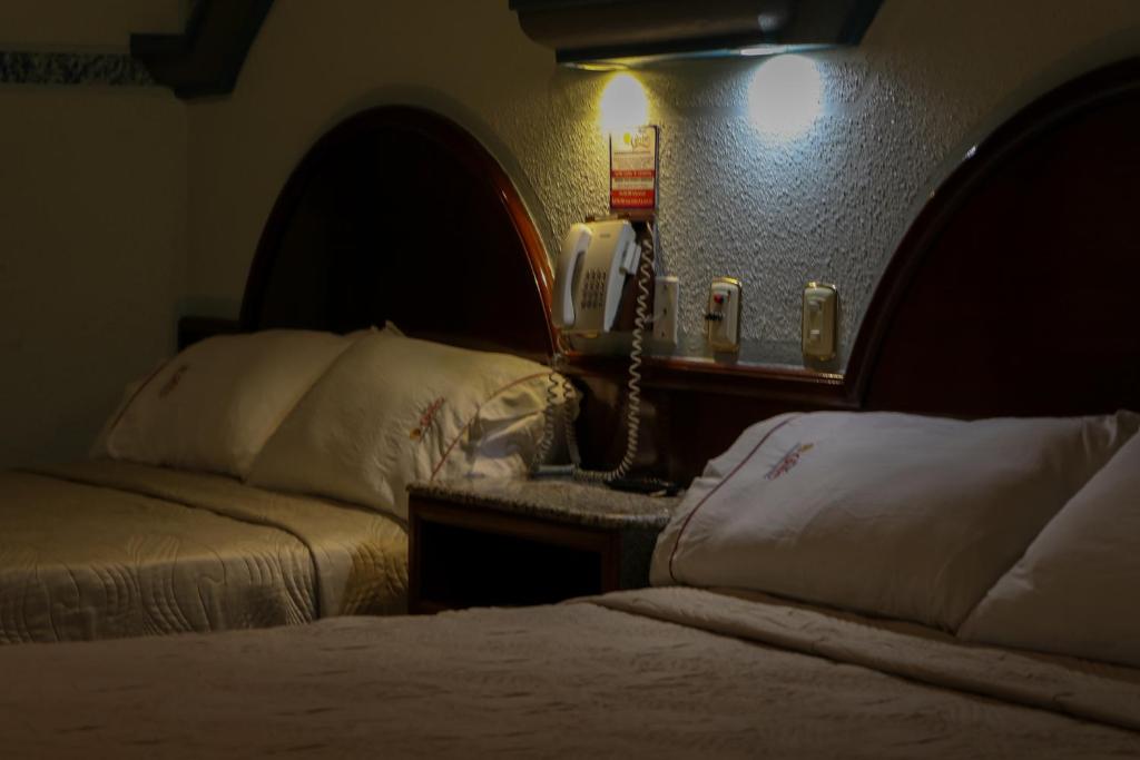 Postel nebo postele na pokoji v ubytování Motel Caribe