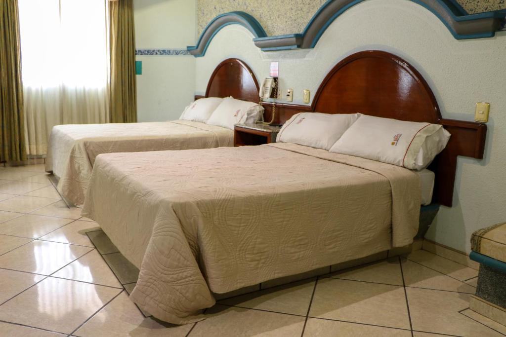 Postel nebo postele na pokoji v ubytování Motel Caribe