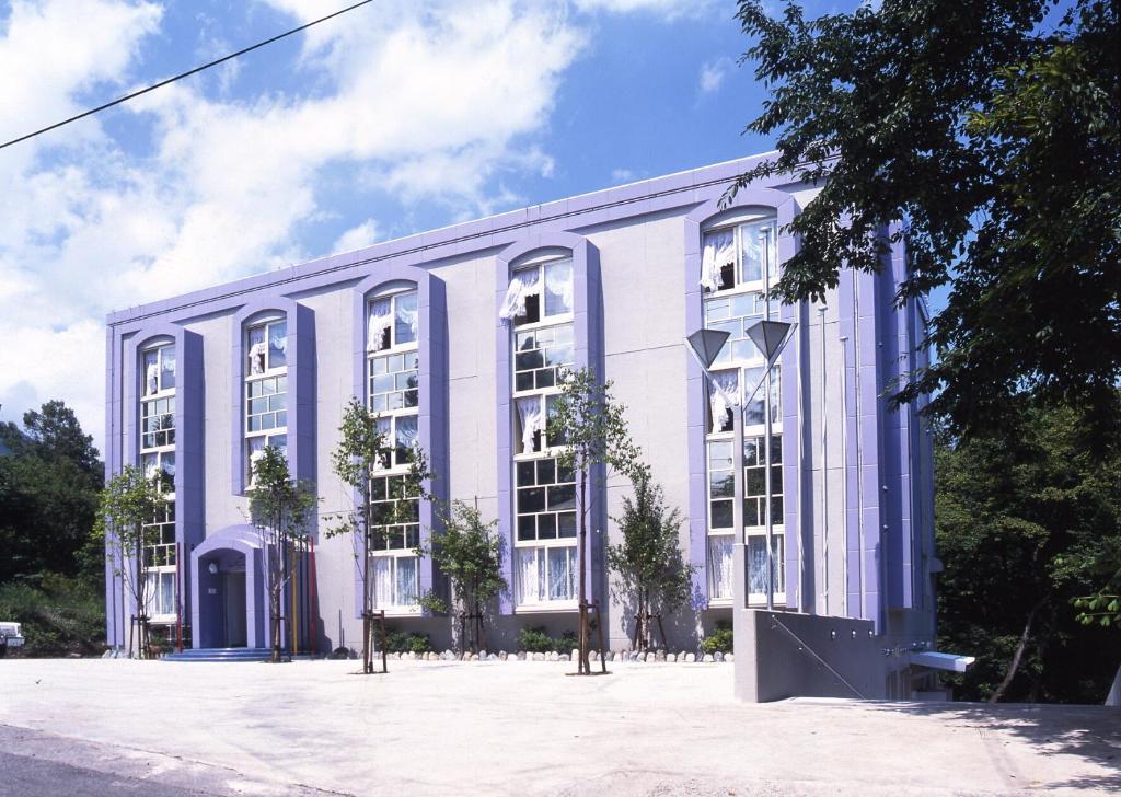 a large white building with white windows at Hakuba King Hotel in Hakuba