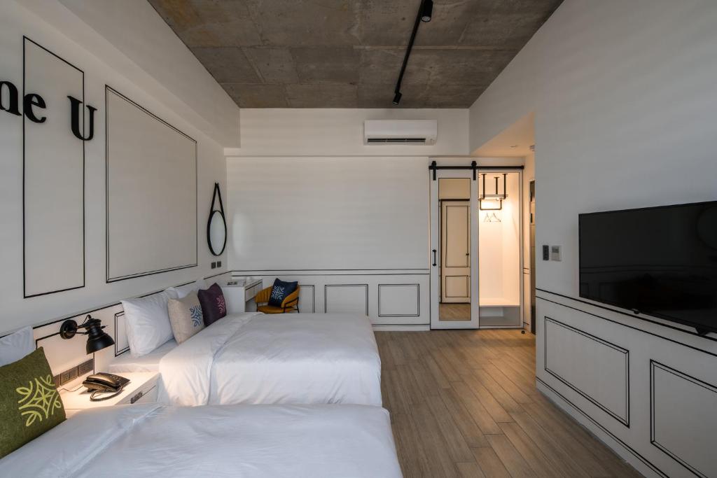 Postel nebo postele na pokoji v ubytování Tian Zhong Hotel