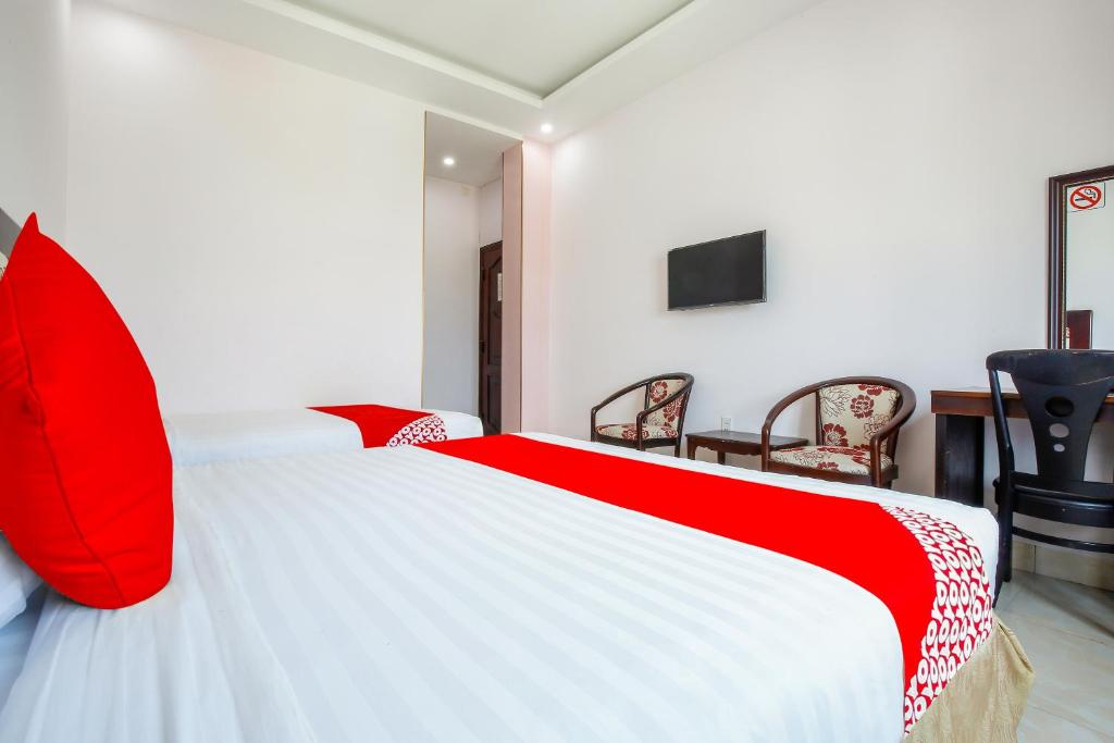 Postel nebo postele na pokoji v ubytování Areca Riverside Đà Nẵng