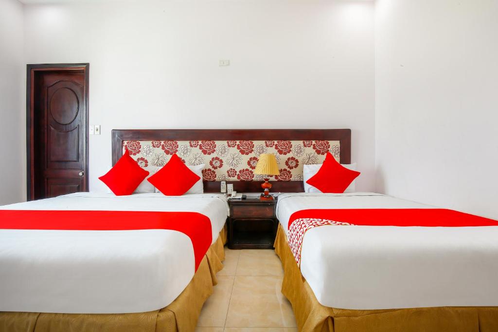 Postel nebo postele na pokoji v ubytování Areca Riverside Đà Nẵng