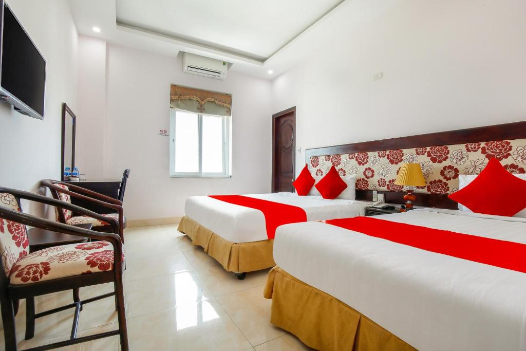 Postel nebo postele na pokoji v ubytování Areca Riverside Đà Nẵng