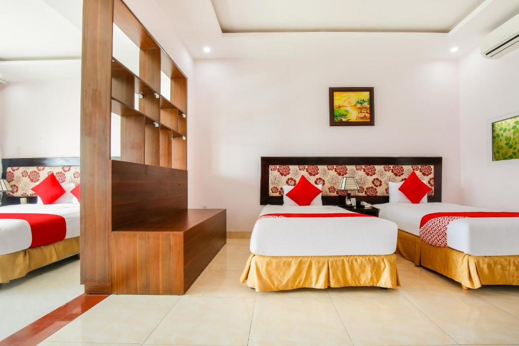 Postel nebo postele na pokoji v ubytování Areca Riverside Đà Nẵng