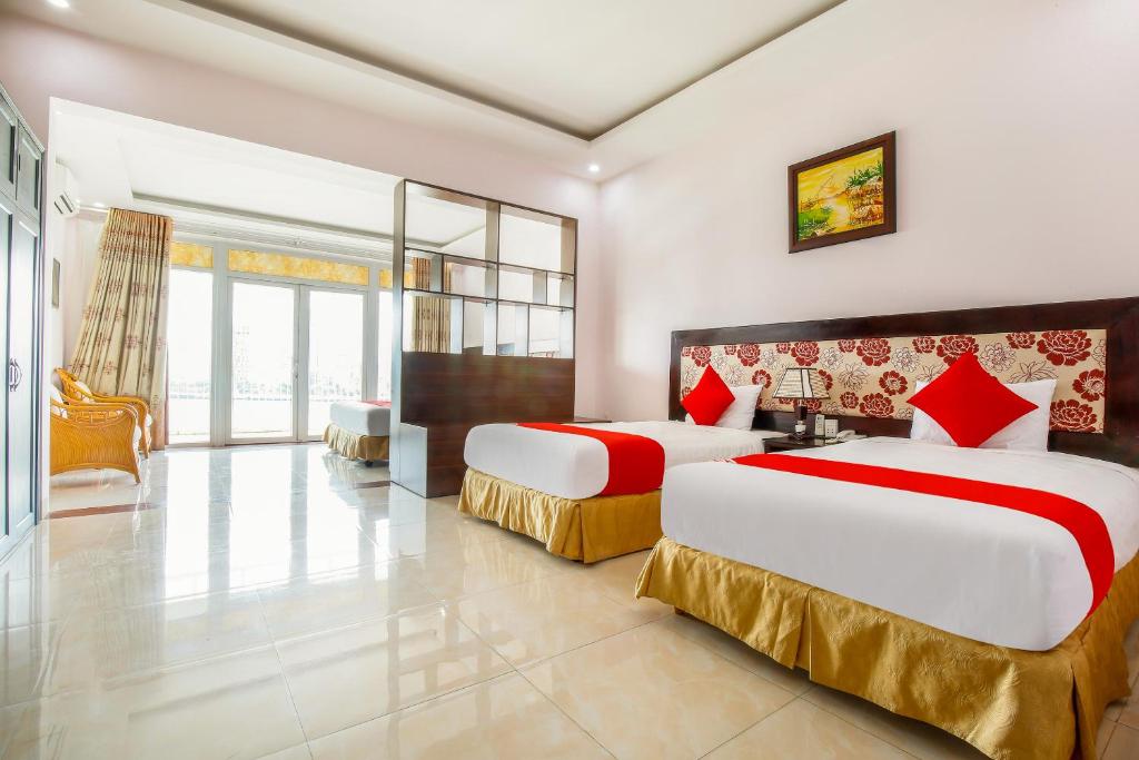 Postel nebo postele na pokoji v ubytování Areca Riverside Đà Nẵng
