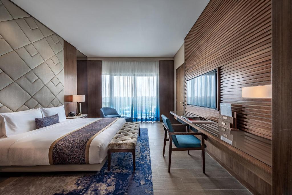 a hotel room with a bed and a desk at Hard Rock Hotel Desaru Coast in Desaru