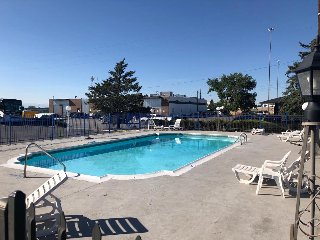 a large swimming pool with chairs at Americas Best Value Inn Denver in Denver