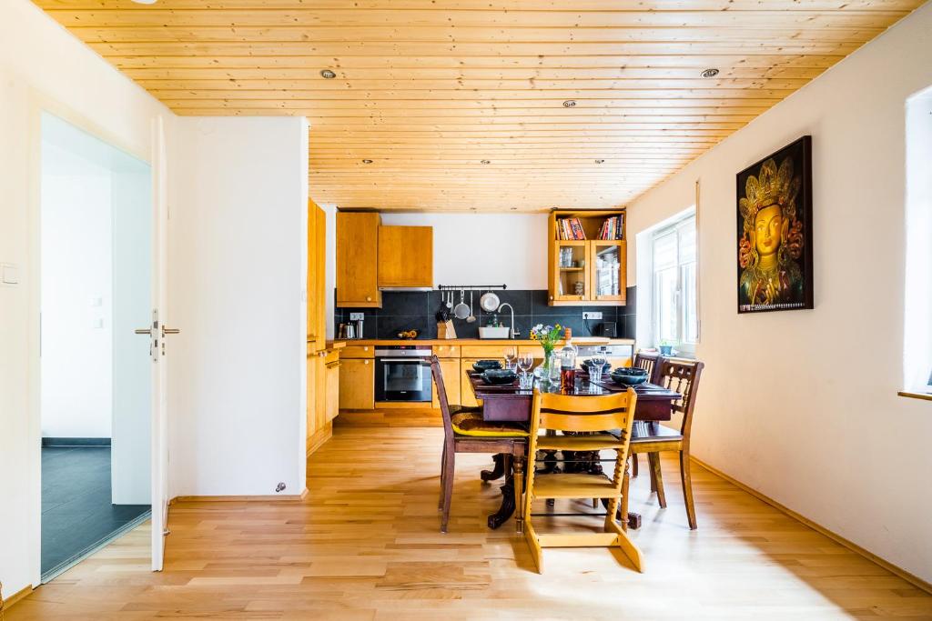 a kitchen with a table and chairs in a room at Cosy Family Home in Tuningen