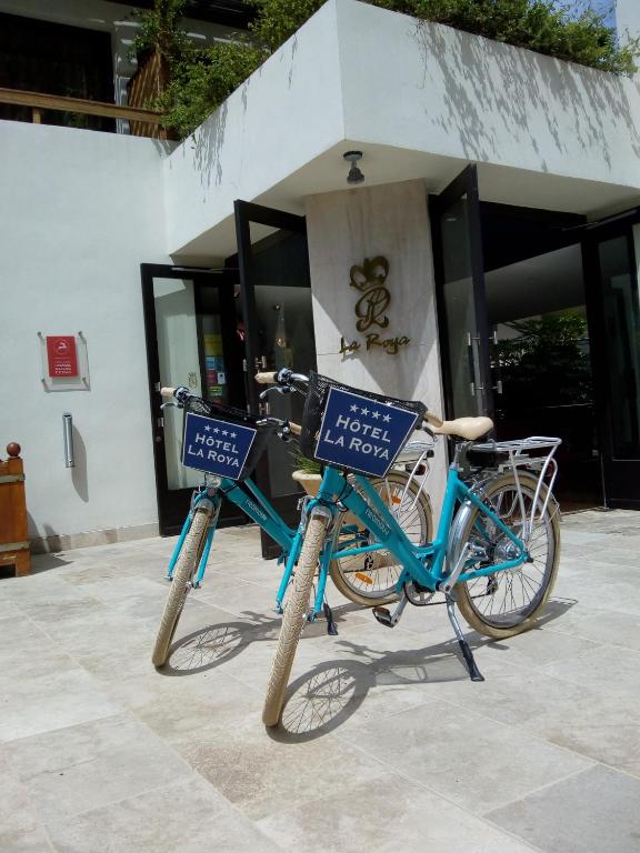two bikes are parked in front of a building at Hôtel La Roya in Saint-Florent