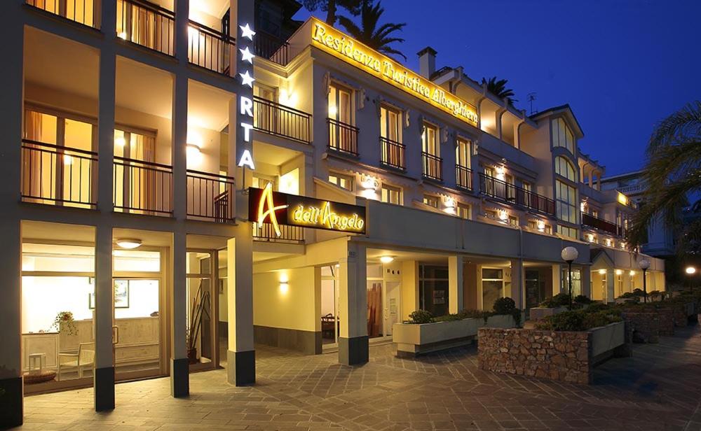 a large building with lights on it at night at Residence Dell'Angelo in Ospedaletti