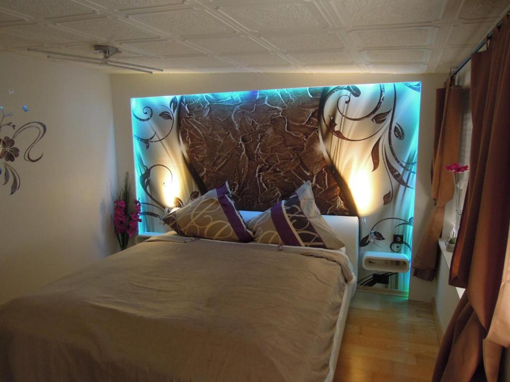 a bedroom with a large bed with lights on it at Ferienwohnung Heyne in Weinböhla