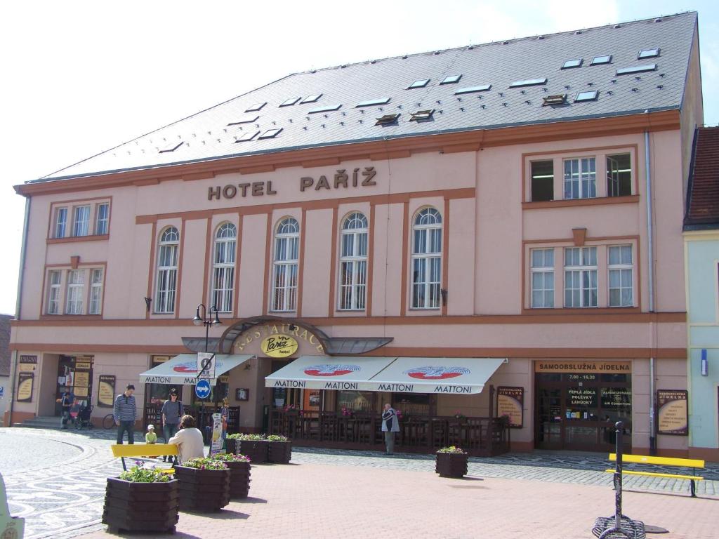 a large building with a hotel patria on a street at Hotel Paříž in Jičín