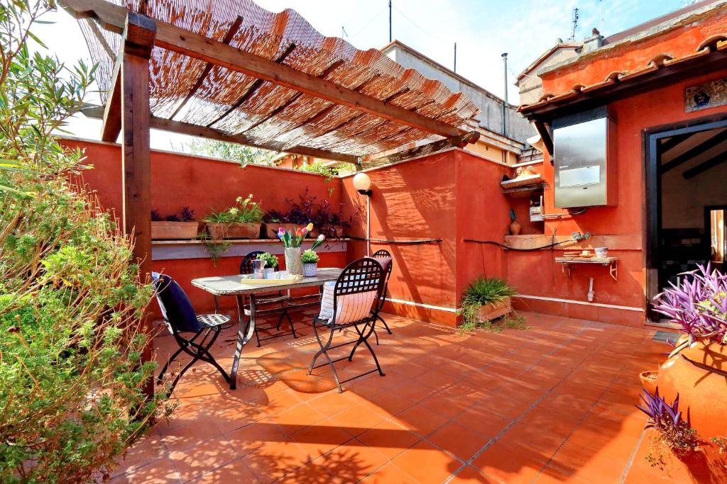 un patio con mesa y sillas. en Tagliamento Apartments, en Roma