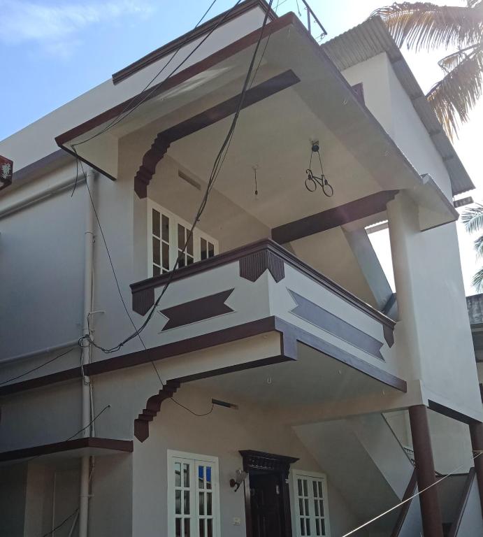 a house with stairs on the side of it at Frangipani Holiday Home in Fort Kochi