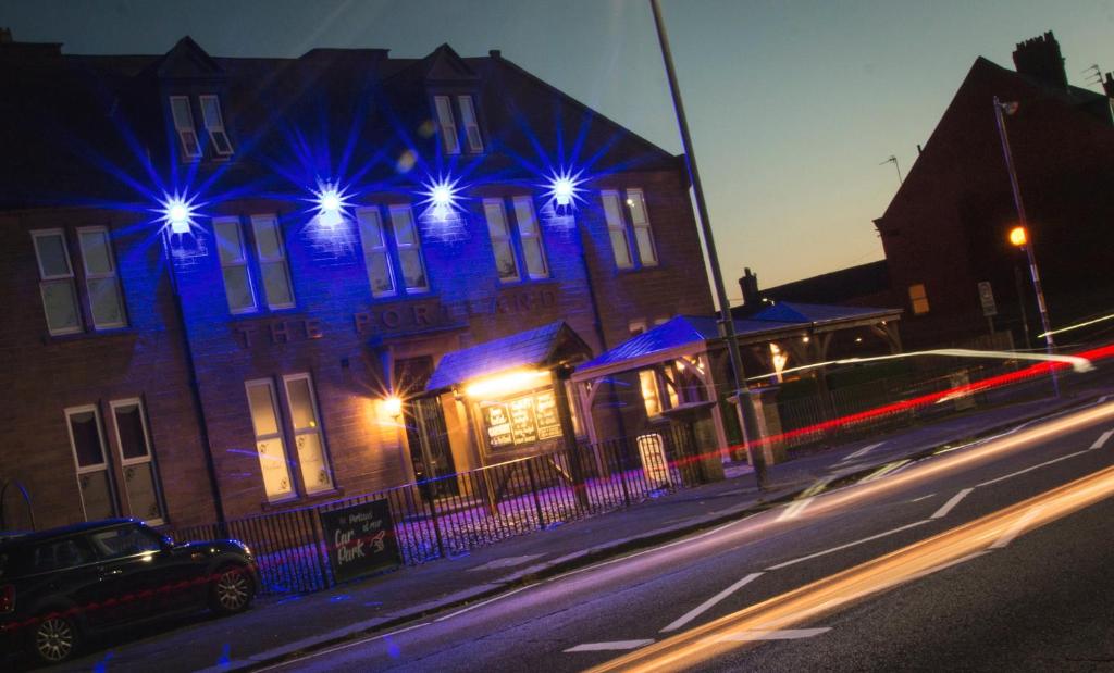a building with blue lights on the side of it at The Portland in Ashington