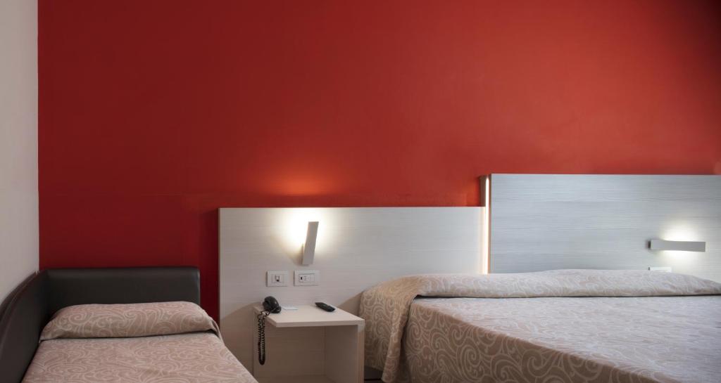 Postel nebo postele na pokoji v ubytování Alfa Fiera Hotel