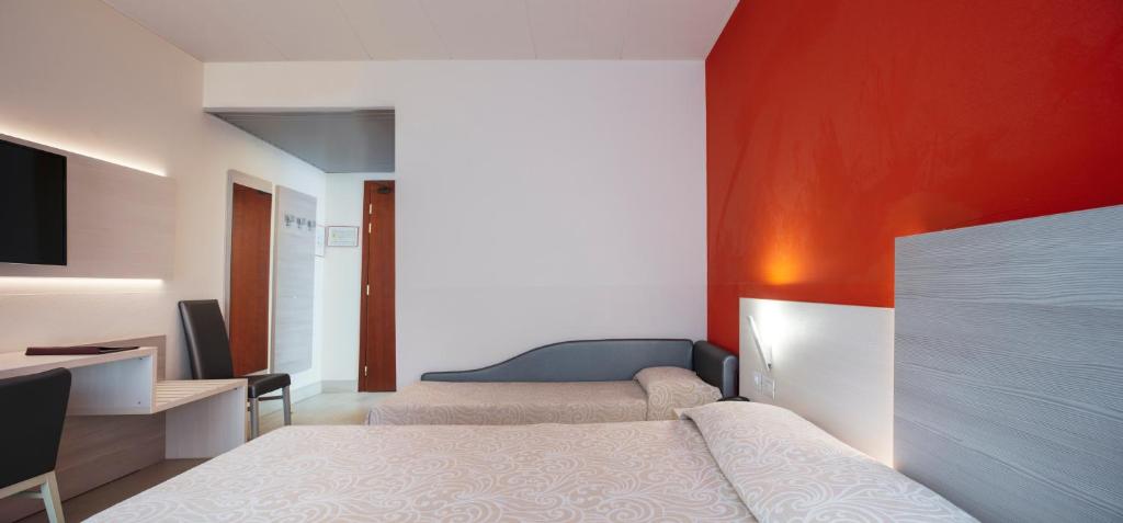 Postel nebo postele na pokoji v ubytování Alfa Fiera Hotel