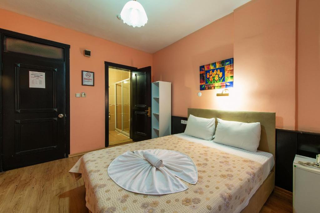 a bedroom with a bed with a pillow on it at EPHESUS CENTRUM in Selcuk