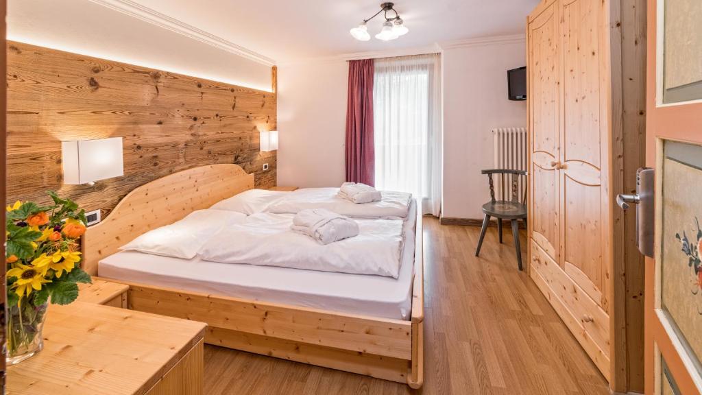Postel nebo postele na pokoji v ubytování Hotel Brunella