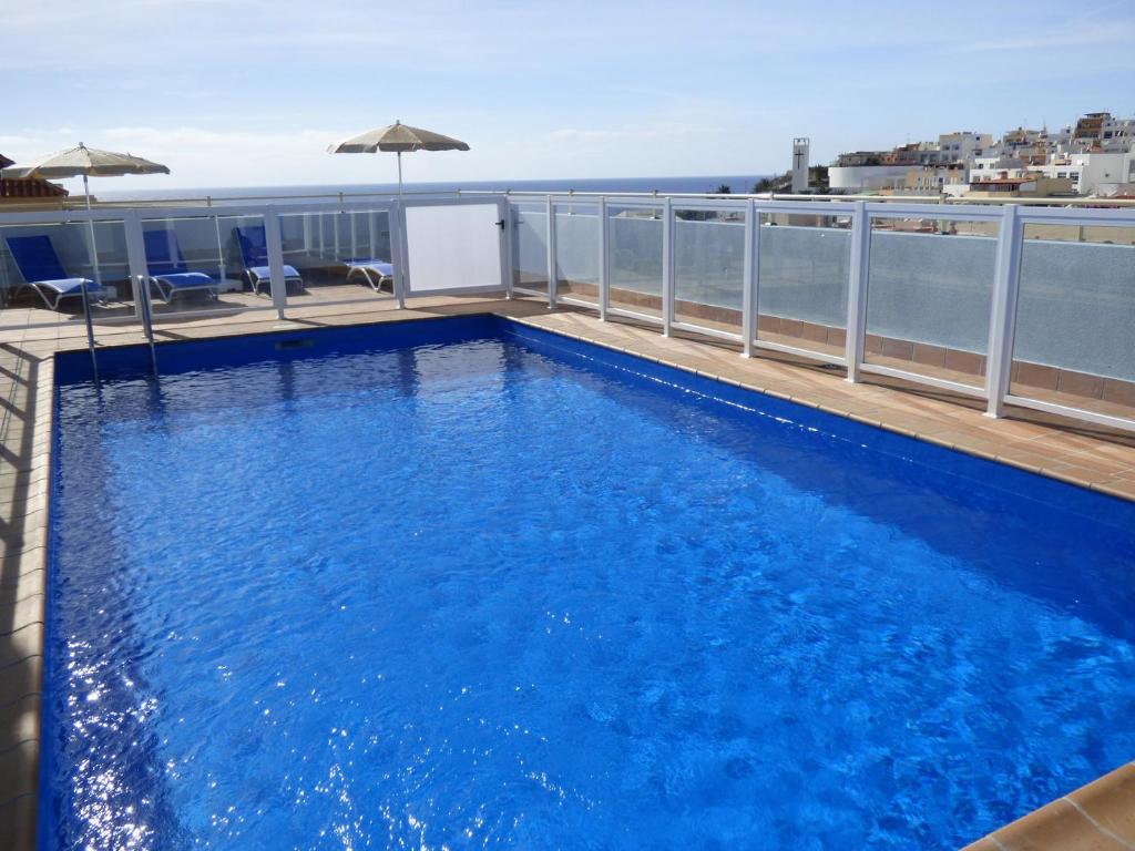 a swimming pool on the roof of a building at galina blanco sosite in Morro del Jable