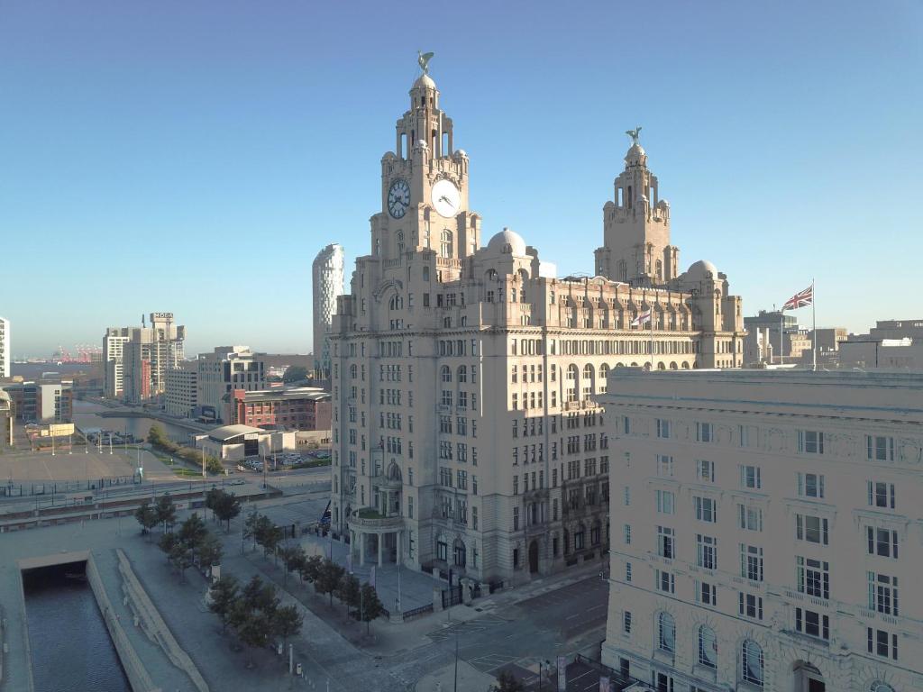 a large building with a clock tower on top of it at Joyce's Liverpool Apartment in Liverpool