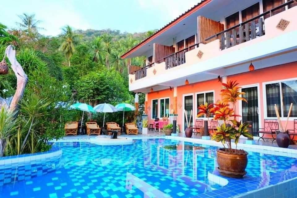 a resort with a swimming pool in front of a building at Sairee View Resort in Koh Tao