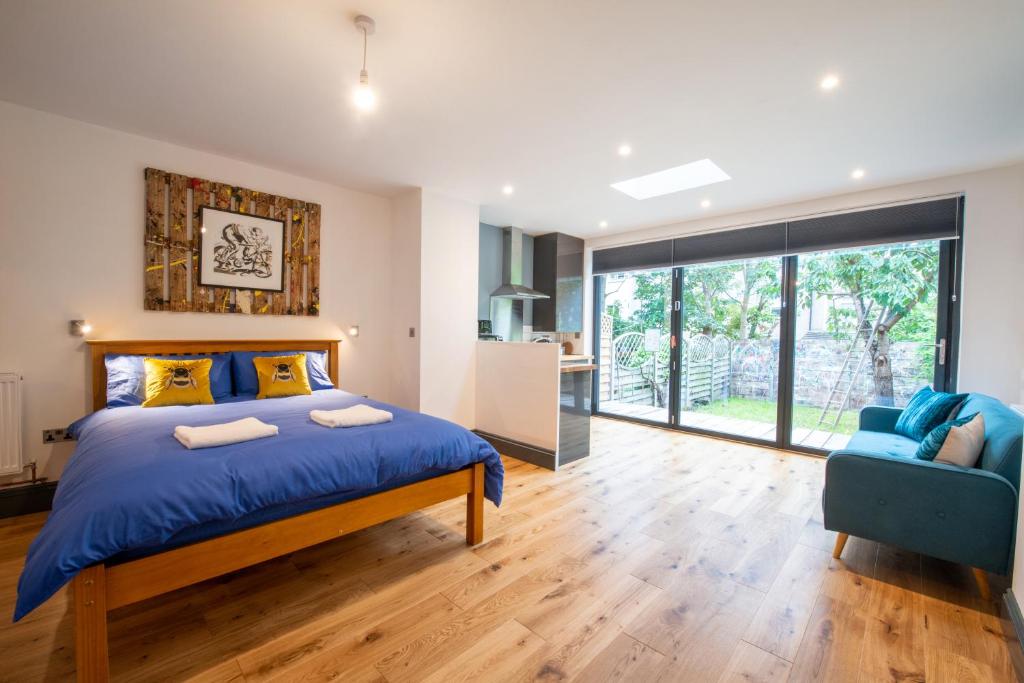 a bedroom with a blue bed and a blue chair at 144 Lower Cheltenham Place in Bristol