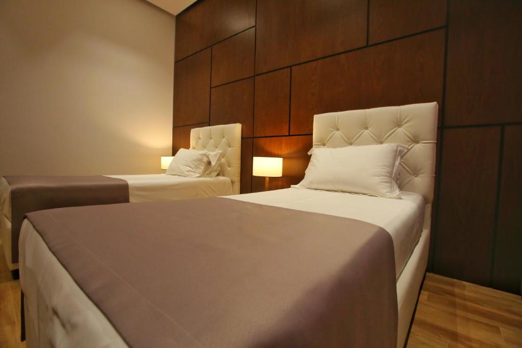 Uma cama ou camas num quarto em Portik Hotel