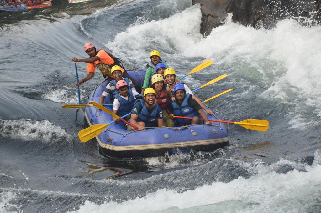 a group of people in a raft in a river at Adventure Inn Dandeli in Kurandi